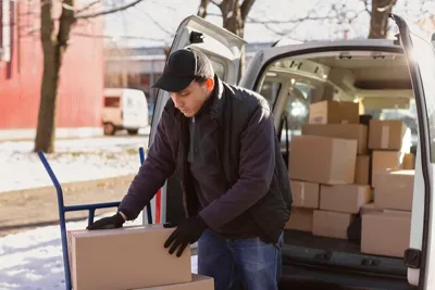 Logistics courier van delivering packages on urban road